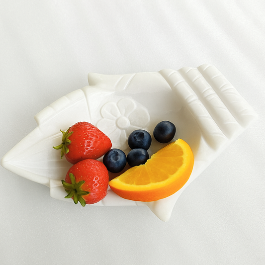 Hand-carved white marble lotus fruit bowl used as a decorative centerpiece or fruit display