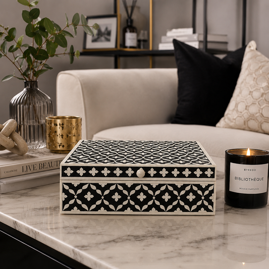 Handmade black Moroccan bone inlay jewelry box on a modern marble coffee table