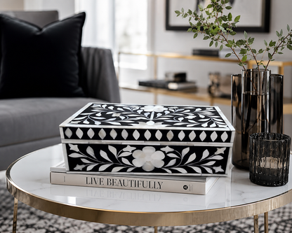 Handmade black bone inlay floral jewelry box displayed open with jewelry inside on a modern dressing table.