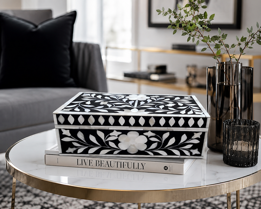 Handmade black bone inlay floral jewelry box displayed open with jewelry inside on a modern dressing table.