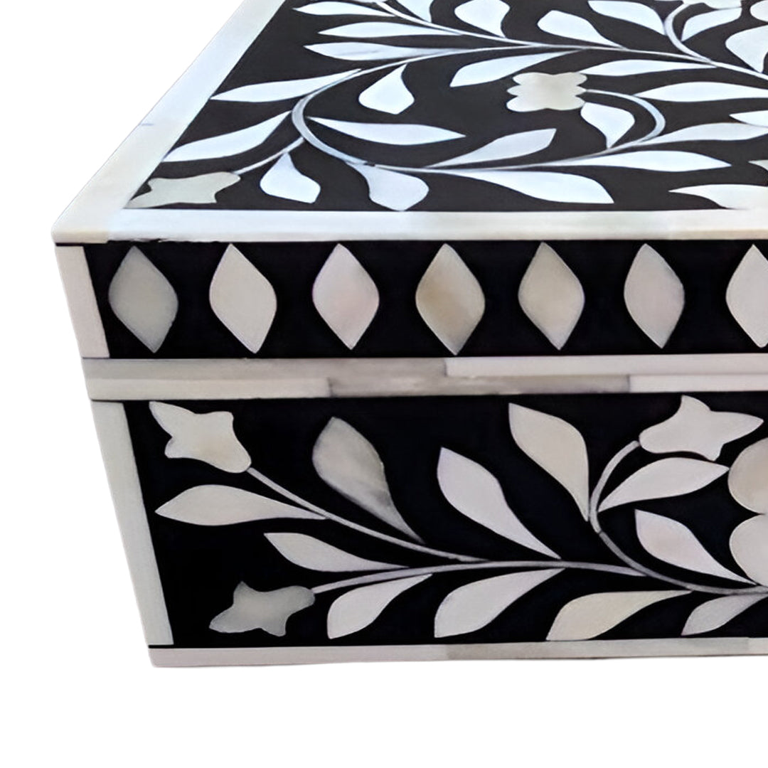 Decorative black bone inlay keepsake box with floral inlay design displayed in a luxury lifestyle interior