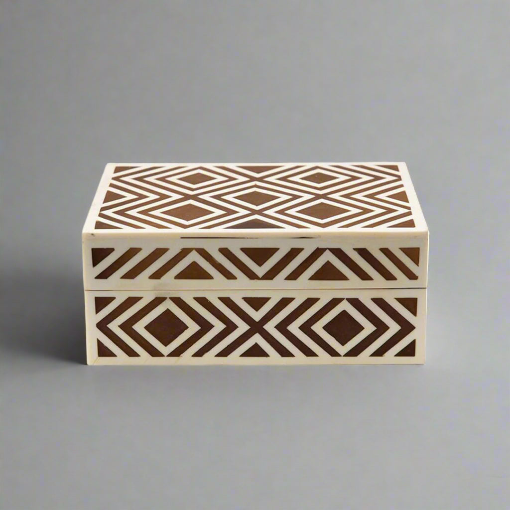 Handmade decorative bone inlay storage box with geometric pattern on a luxury dressing table