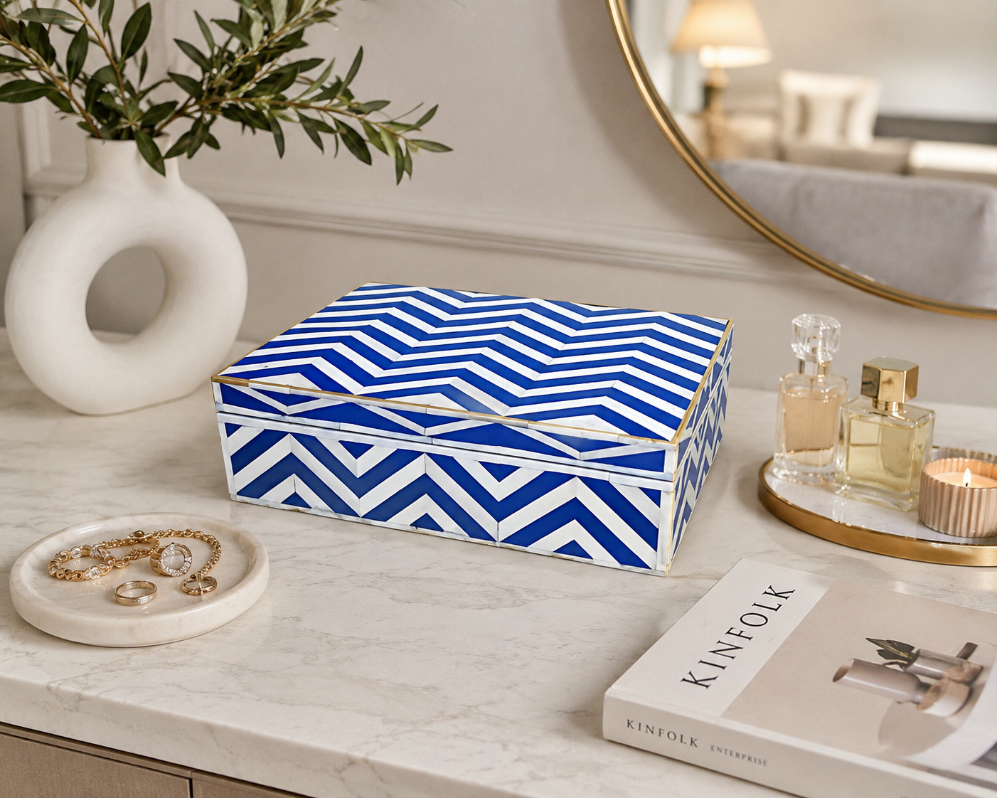 Handmade blue and white chevron bone inlay jewelry box on a modern marble vanity table