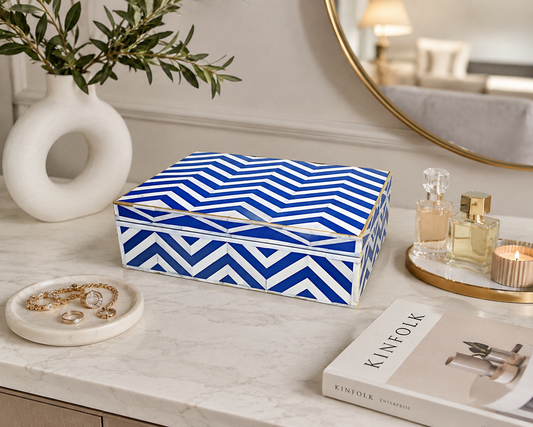 Handmade blue and white chevron bone inlay jewelry box on a modern marble vanity table