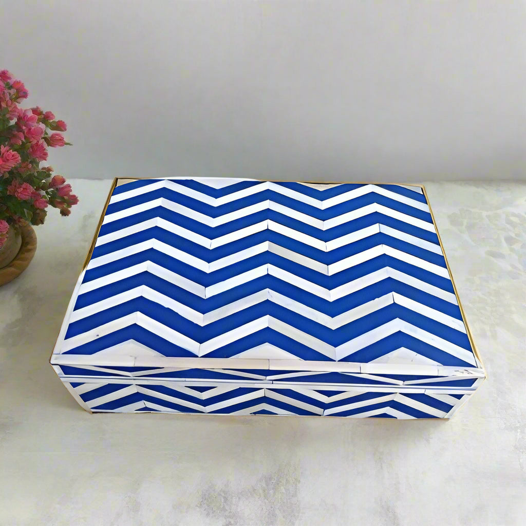 Handmade blue and white chevron bone inlay jewelry box styled on a modern marble vanity table
