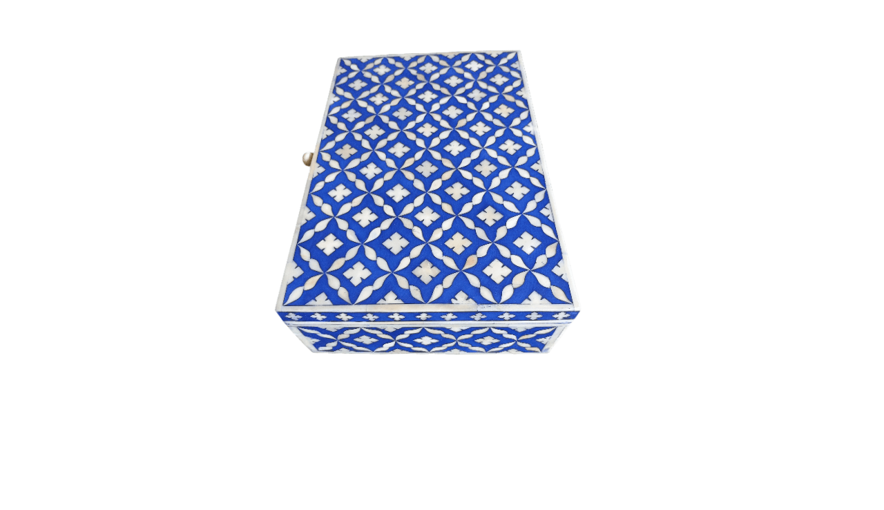 Decorative bone inlay jewelry box with blue Moroccan inlay design on a luxury dresser