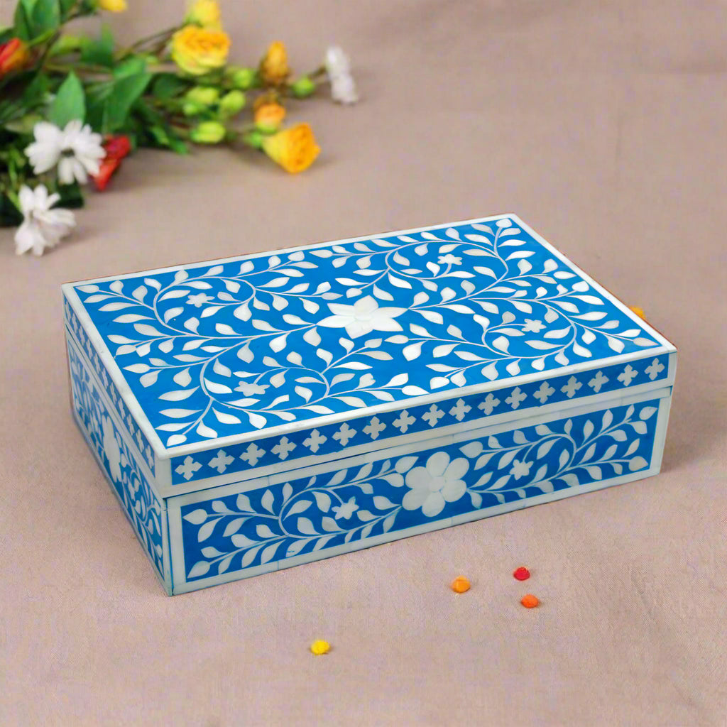 Handmade blue floral bone inlay jewelry box styled on a luxury marble vanity table