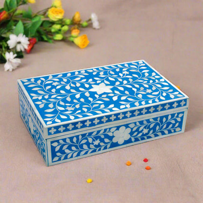 Handmade blue floral bone inlay jewelry box styled on a luxury marble vanity table