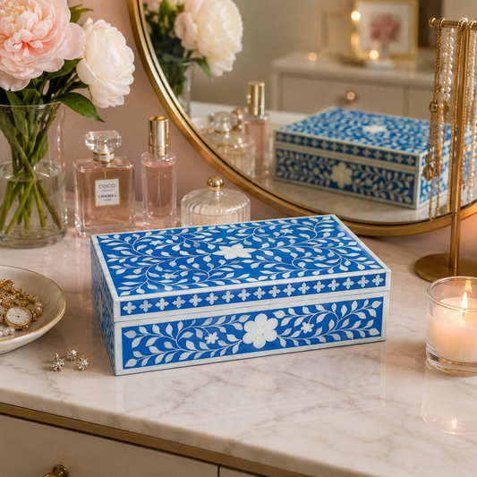 Handmade blue floral bone inlay jewelry box on a luxury marble vanity table with perfume and flowers