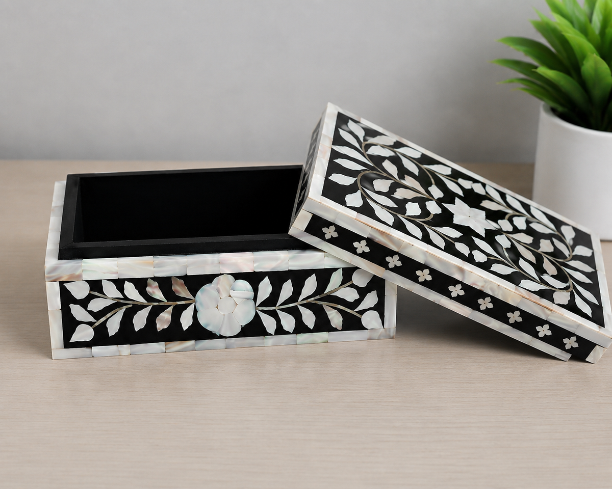 Open black mother of pearl jewelry box with removable lid and floral inlay design.