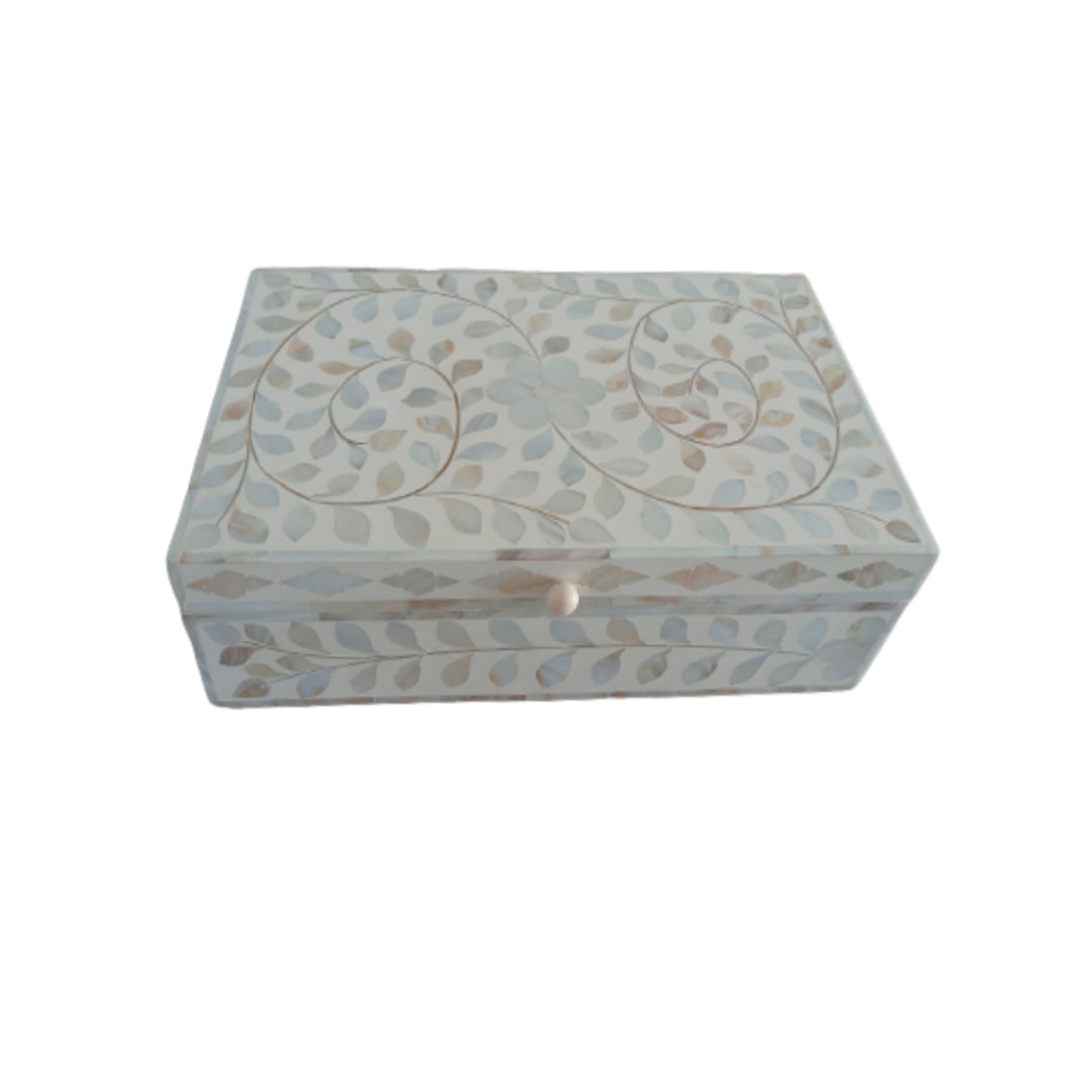 Floral bone inlay jewelry box adding elegance to a vanity and bedside table
