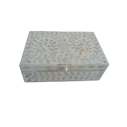 Floral bone inlay jewelry box adding elegance to a vanity and bedside table