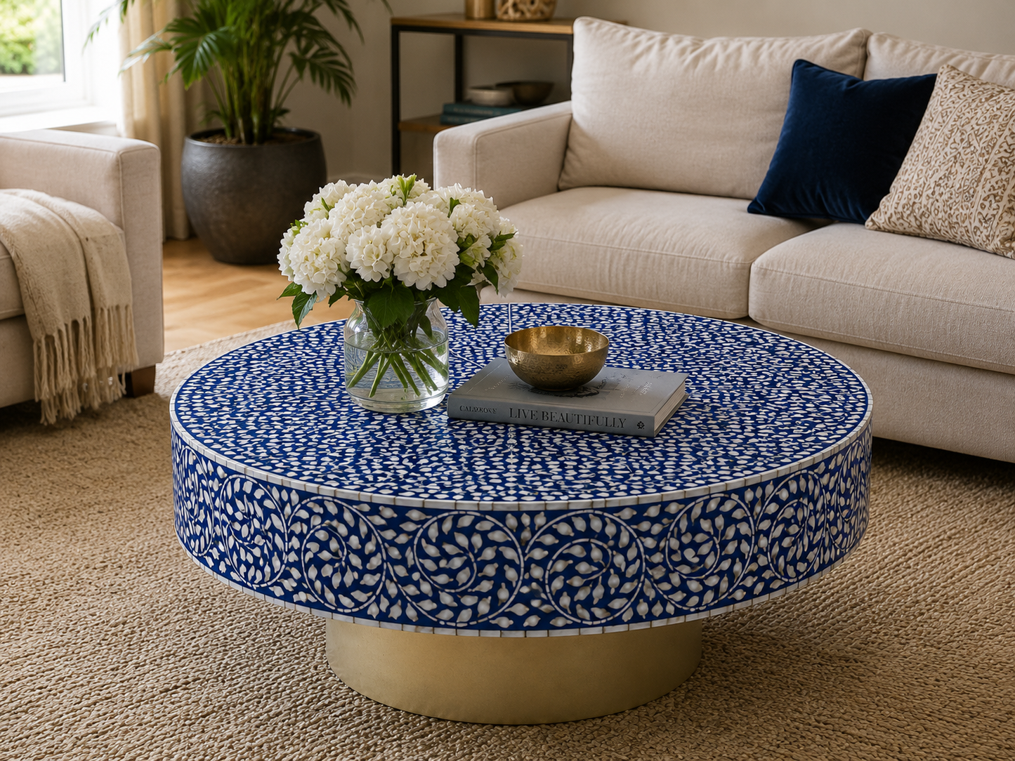Luxury blue bone inlay round coffee table styled in a modern living room with floral decor