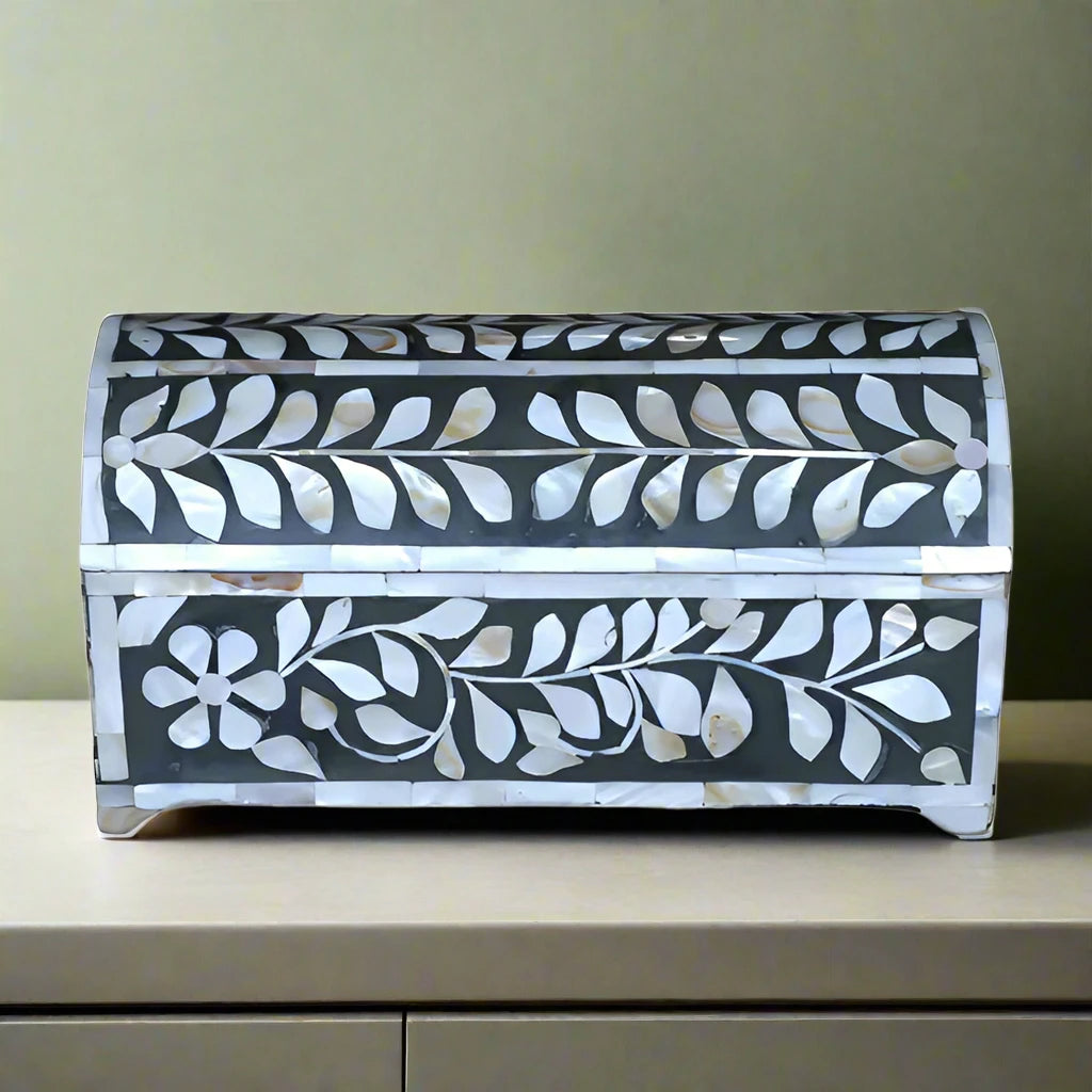 Front view of handmade mother of pearl jewelry box with floral vine inlay and curved lid