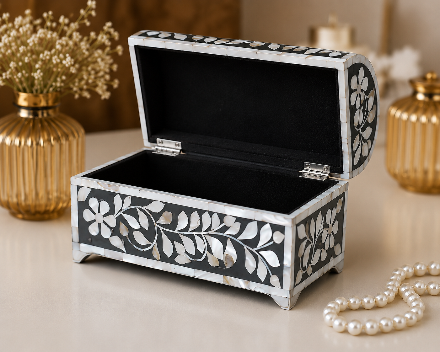 Close-up detail of floral vine mother of pearl inlay on curved jewelry box lid