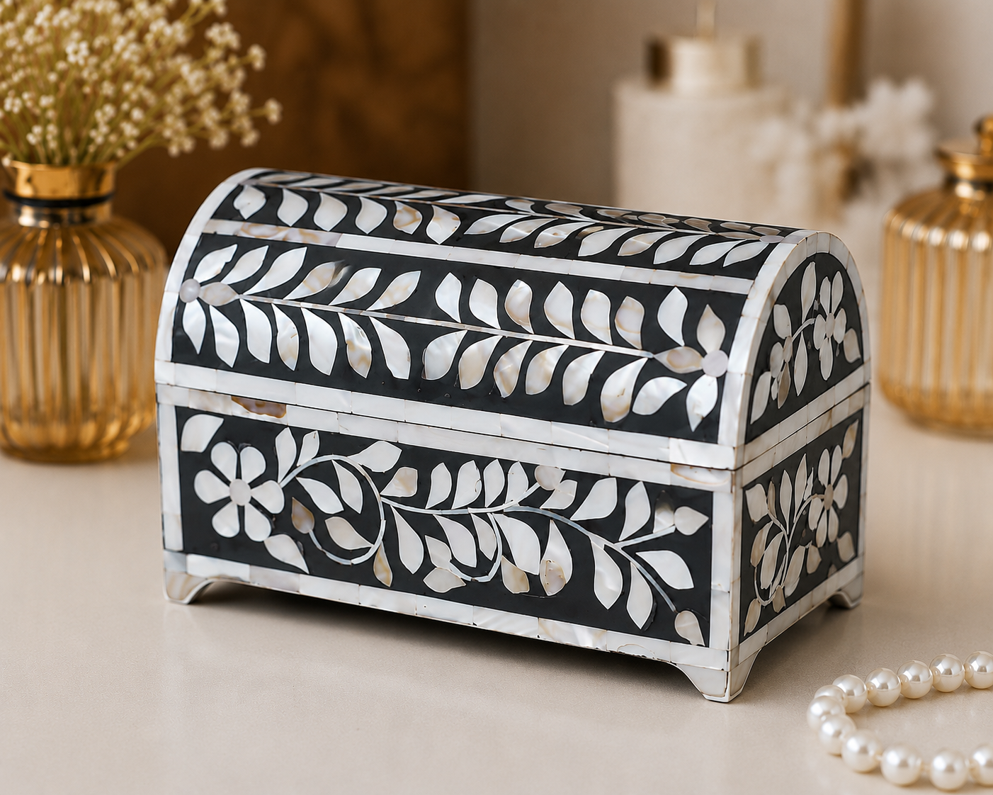 Top view of handmade mother of pearl jewelry box showcasing intricate floral vine pattern