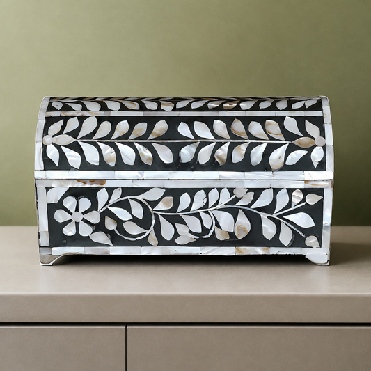 Angled side view of handcrafted mother of pearl jewelry box featuring floral vine design