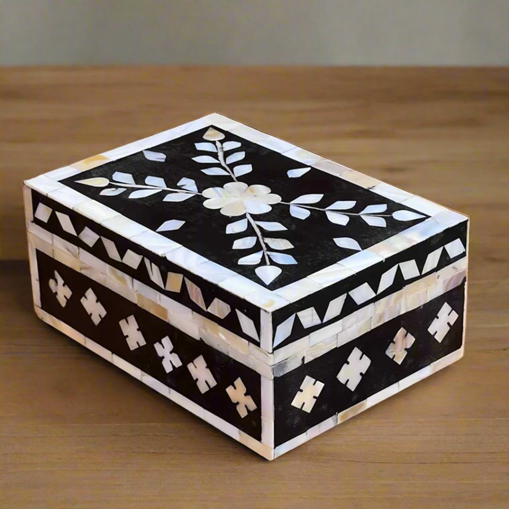 Black mother of pearl inlay jewelry box with floral motif.
