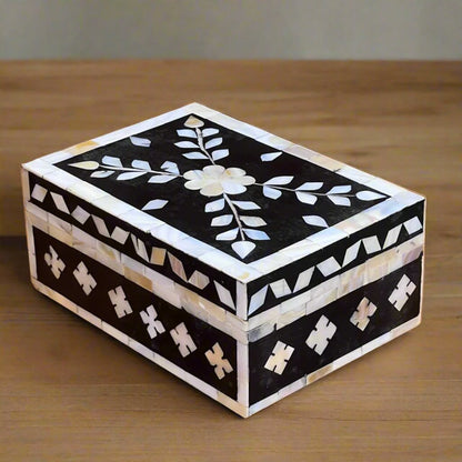 Black mother of pearl inlay jewelry box with floral motif.