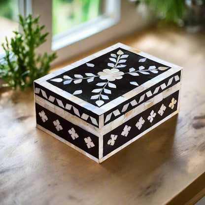 Elegant mother of pearl keepsake box with geometric border.