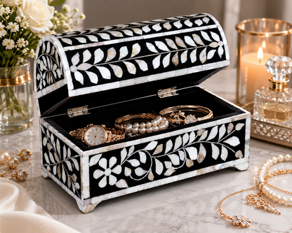 Artisan-made Mother of Pearl keepsake box styled with perfume, candles, and pearls