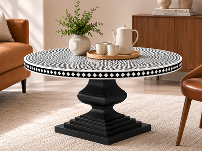 Luxury black and white bone inlay round dining table with handcrafted geometric pattern in a modern dining room.