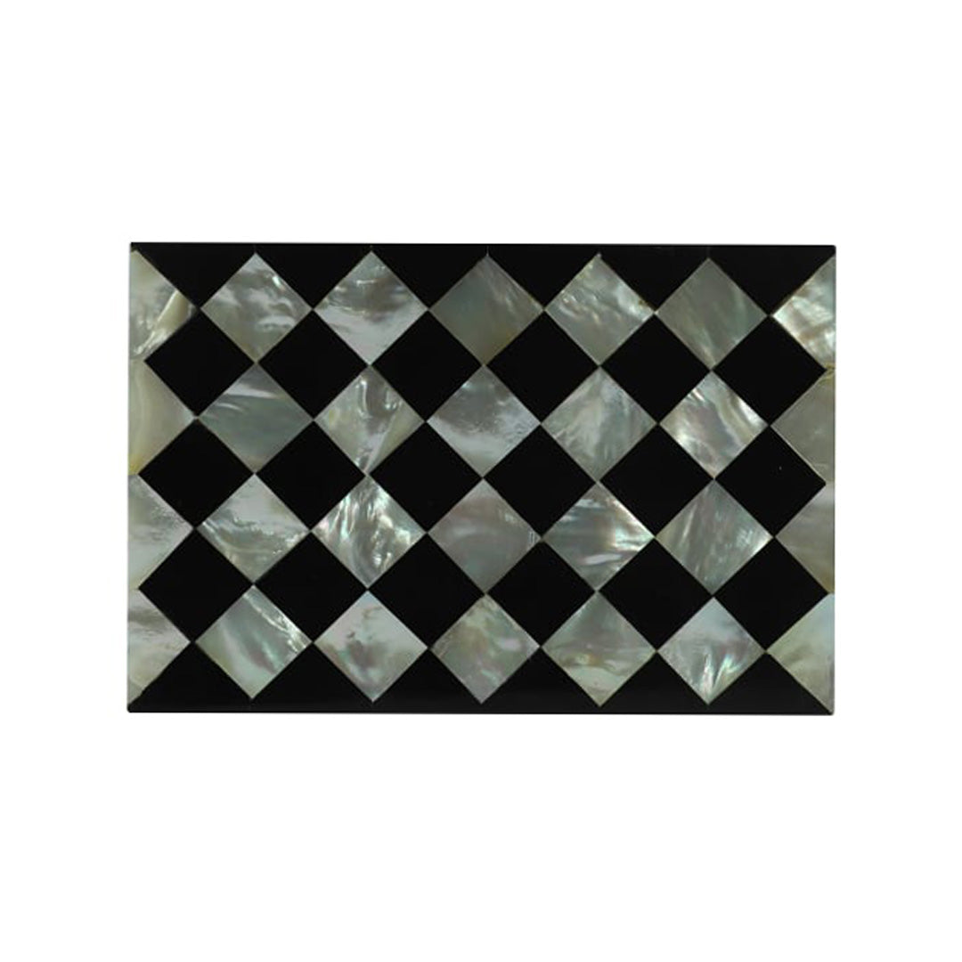 Artisan-crafted Mother of Pearl jewelry storage box with black geometric design on a soft beige fabric backdrop.