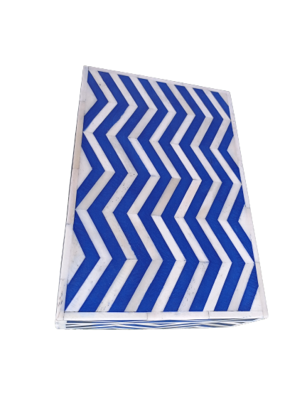Modern lifestyle image of a handmade bone inlay jewelry box with blue chevron design