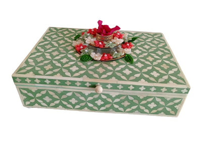 Decorative teal bone inlay keepsake box with geometric Moroccan design in a luxury lifestyle setting.