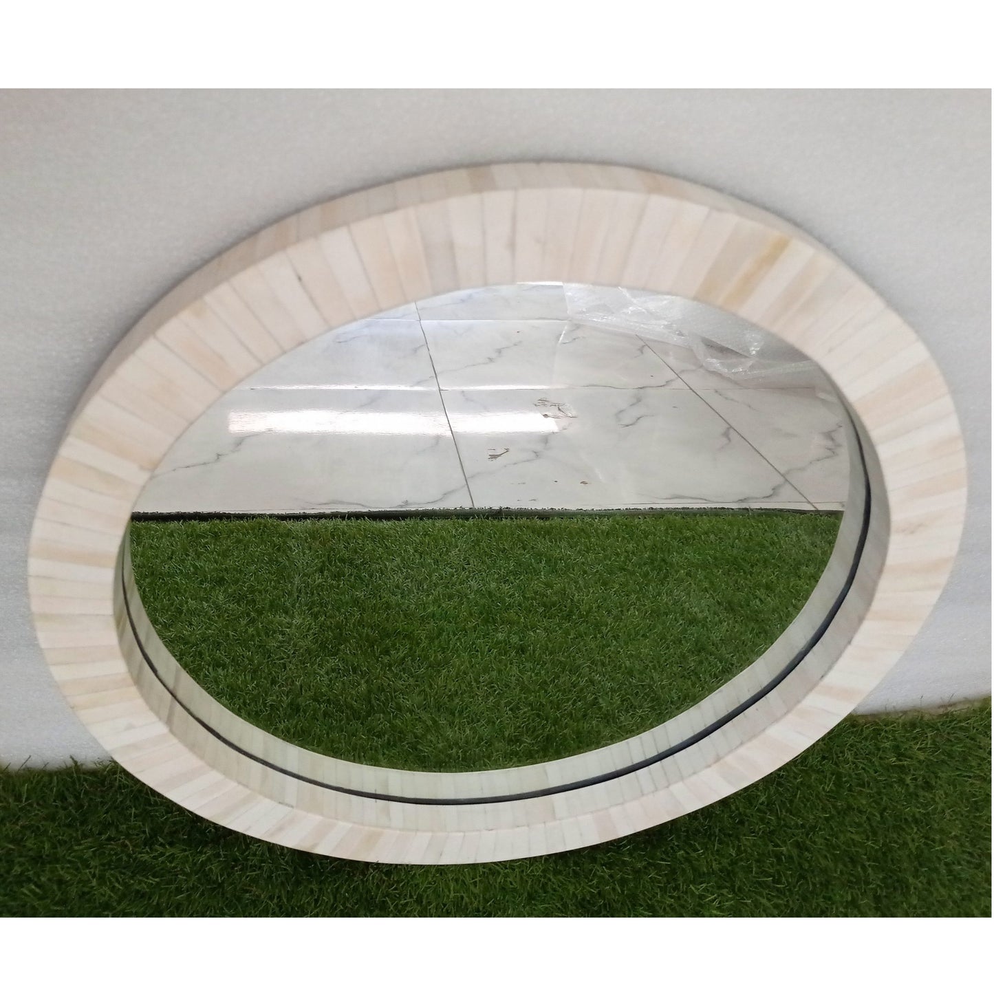 Custom bone inlay round wall mirror with neutral modern styling and luxury home furnishings.