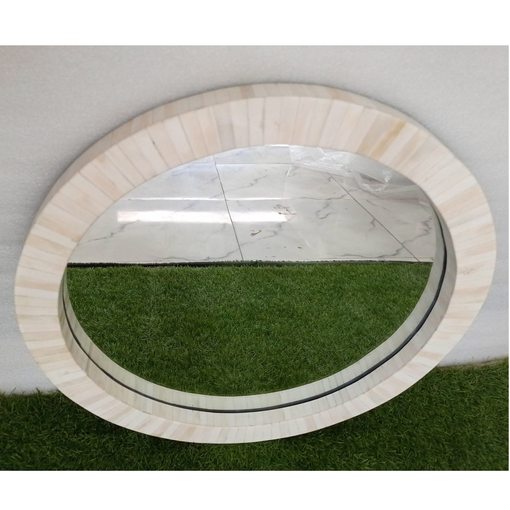 Custom bone inlay round wall mirror with neutral modern styling and luxury home furnishings.