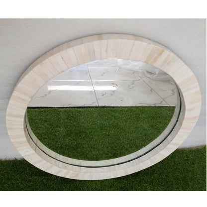 Custom bone inlay round wall mirror with neutral modern styling and luxury home furnishings.
