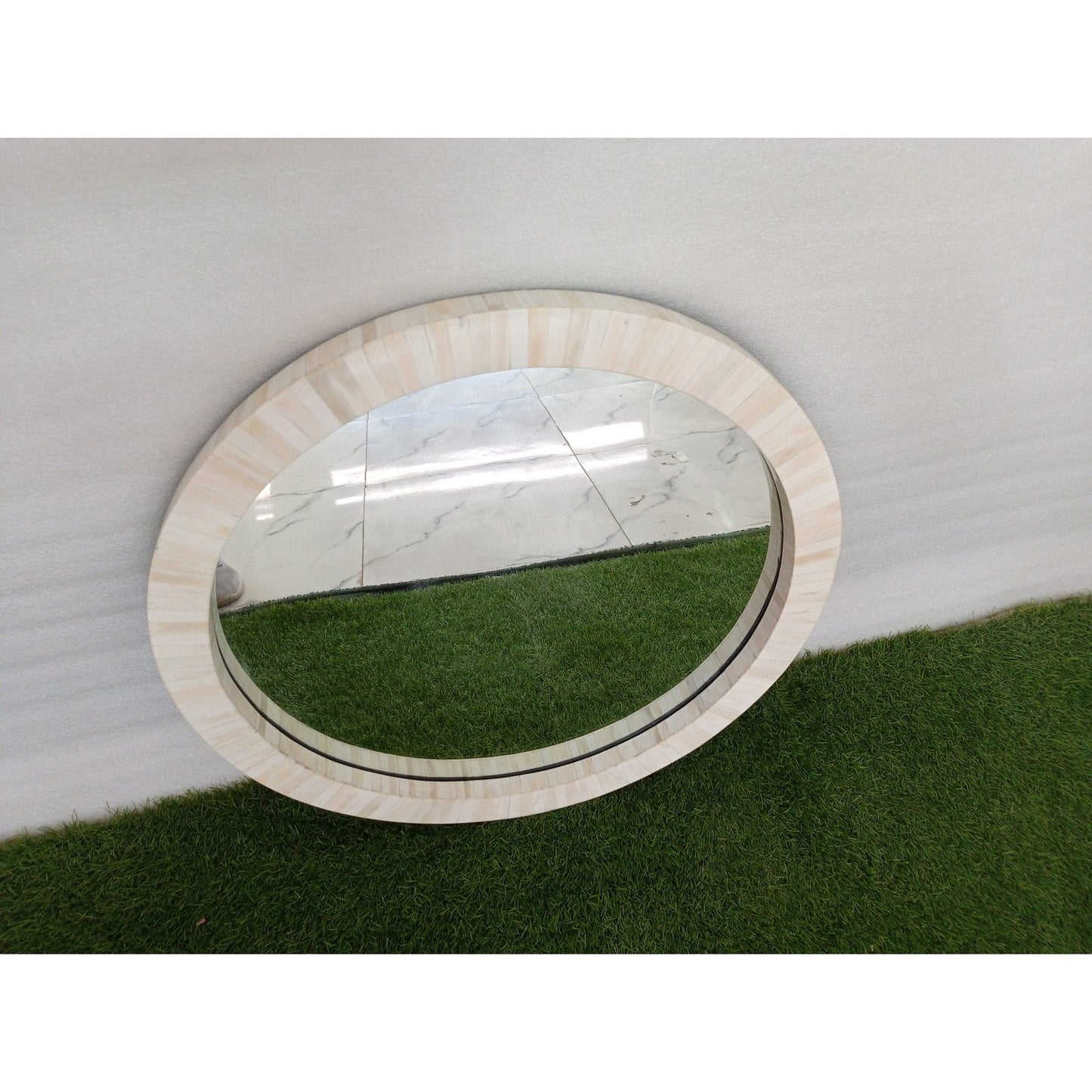 Artisan-crafted bone inlay round mirror frame adding texture and elegance to contemporary wall decor